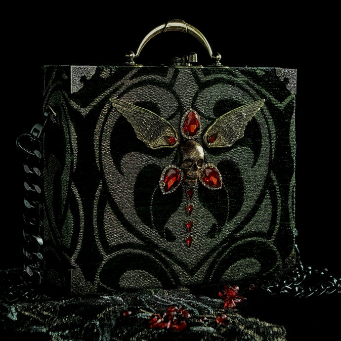 Black and gold winged skull hand bag