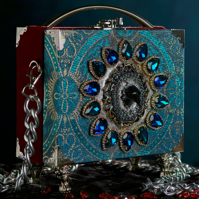Raven head on turquoise brocade and cristals
