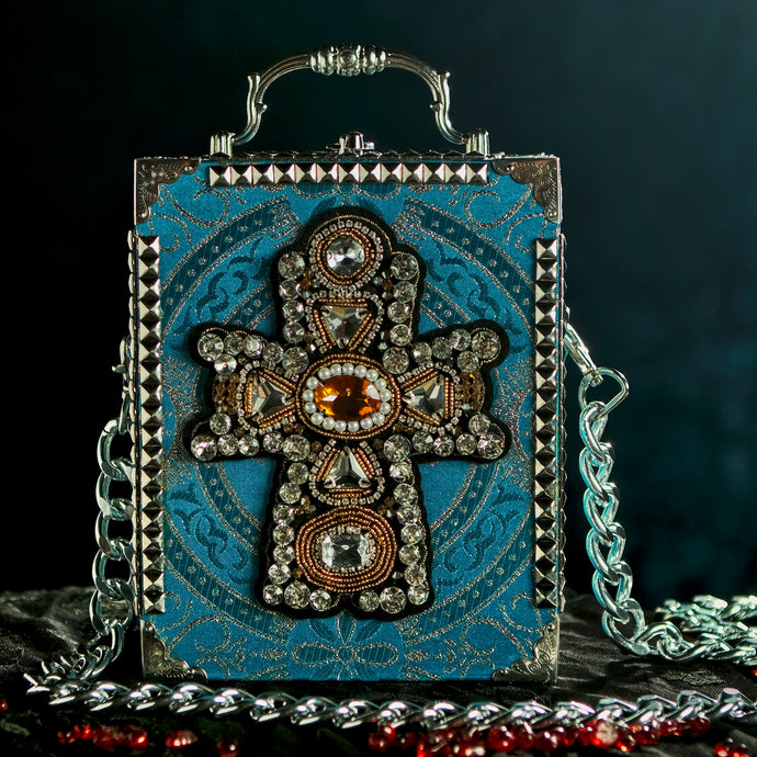 Yellow and clear rhinestones cross applique on turqoise brocade hand bag