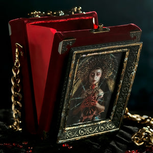 Framed Virgin of Sorrows on red velvet hand bag