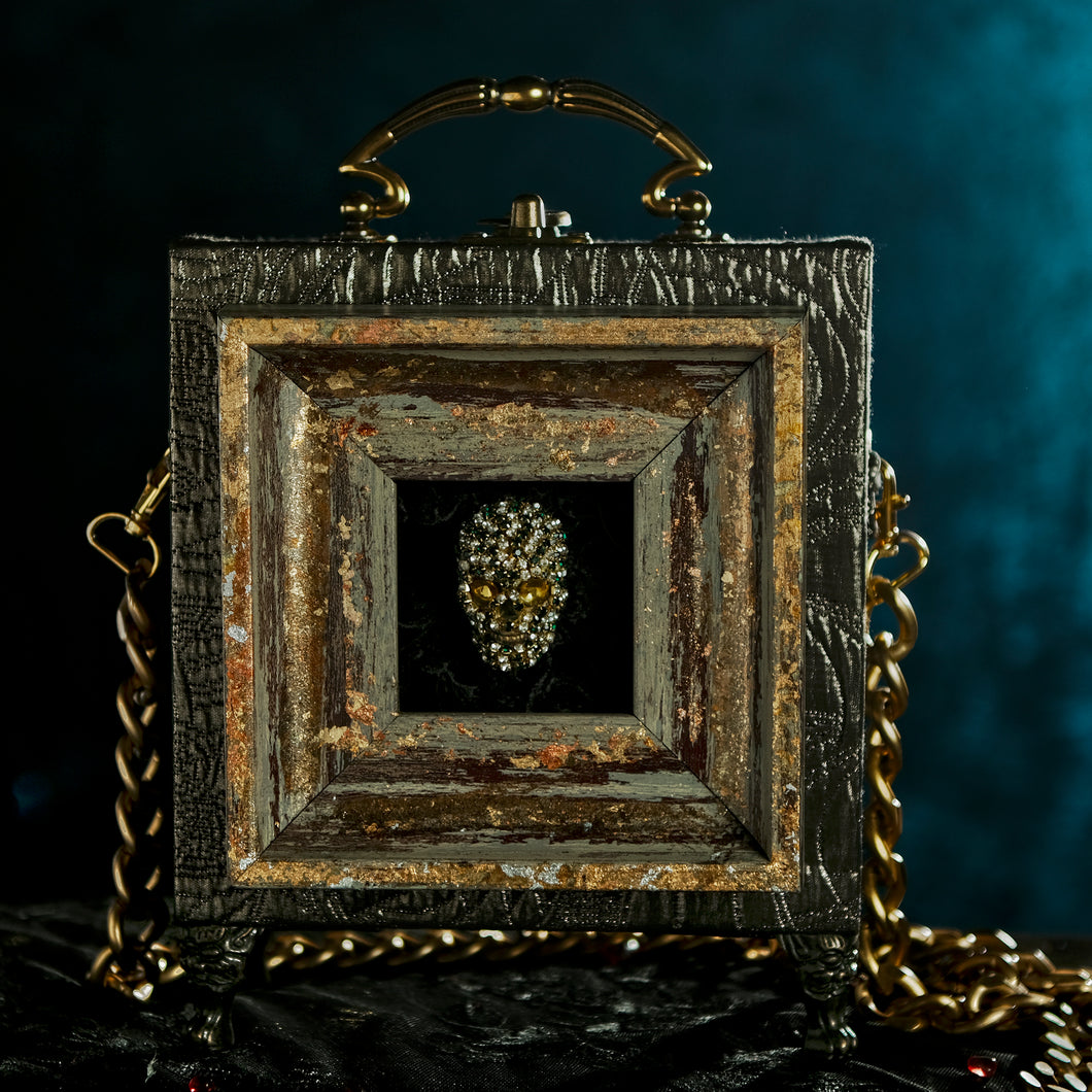 Rhinestones skull framed on a bronze brocade hand bag