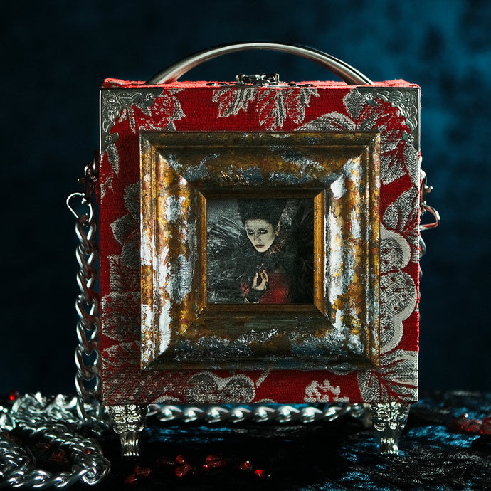 Framed Bloody Mary on a red brocade handbag