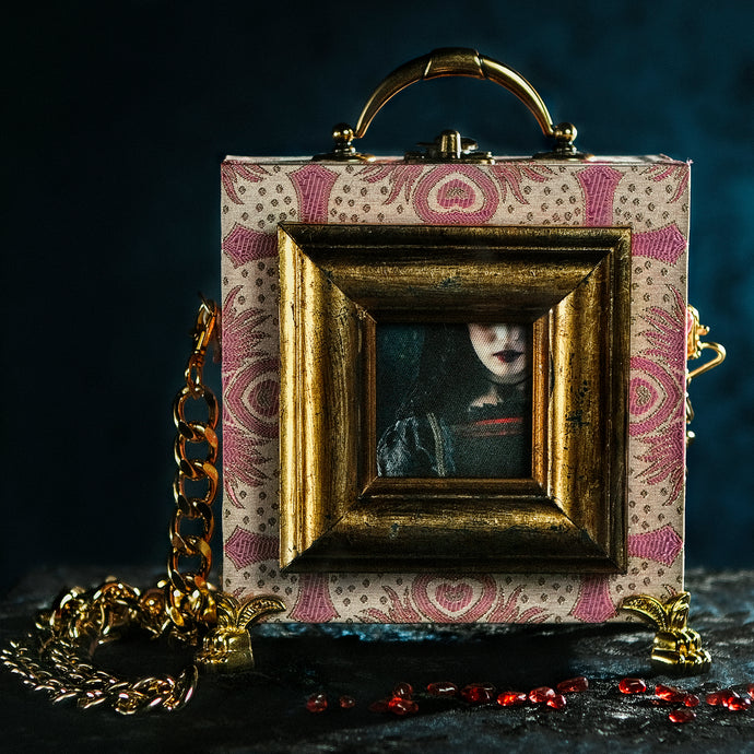 Framed Joan the Mad lips on a pink brocade handbag