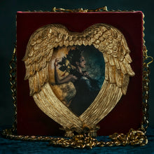 Load image into Gallery viewer, Kaos goddess in a hand carved heart frame hand bag