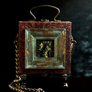 Framed Virgin of Quito on a red and cyan brocade